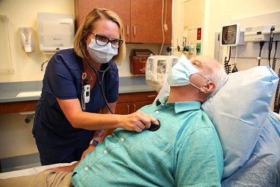 Doctor checking Veteran's heart rate