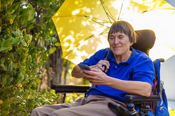 Veteran in wheelchair receiving text message appointment reminder on her cell phone 