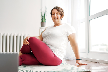 A person sits down and stretches.